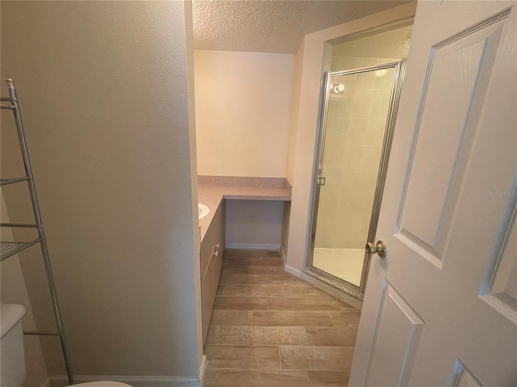 1122 South Pine Ridge Circle, Unit 1122 Sanford, FL 32773 - Photo 11 of 19 a bathroom with a sink and a mirror