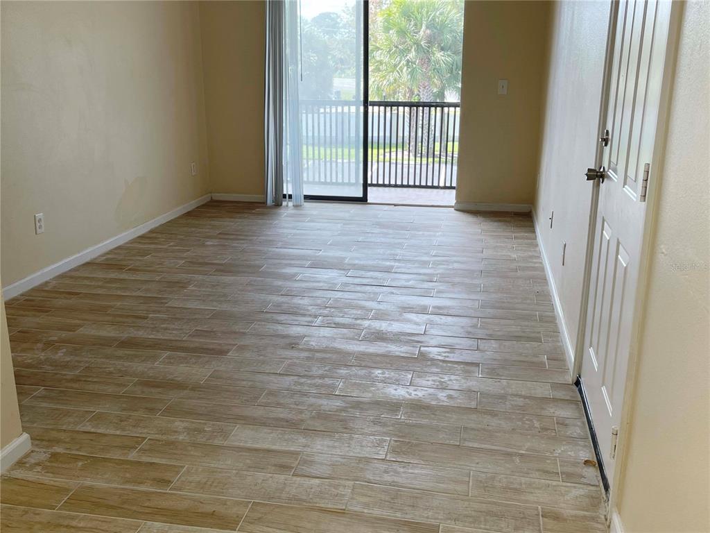 1122 South Pine Ridge Circle, Unit 1122 Sanford, FL 32773 - Photo 15 of 19 a view of a room with wooden floor and a window