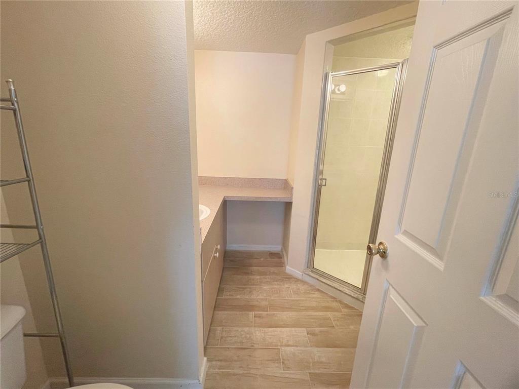 1122 South Pine Ridge Circle, Unit 1122 Sanford, FL 32773 - Photo 16 of 19 a bathroom with a sink and a mirror