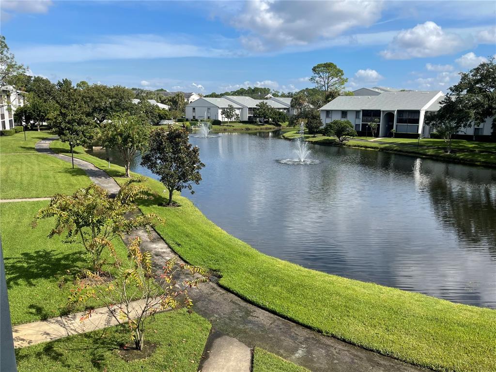1122 South Pine Ridge Circle, Unit 1122 Sanford, FL 32773 - Photo 19 of 19 a view of a lake with a city
