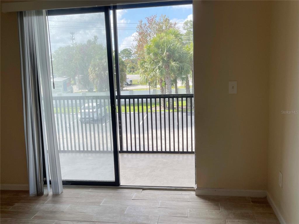 1122 South Pine Ridge Circle, Unit 1122 Sanford, FL 32773 - Photo 3 of 19 a view of a glass door with a glass door