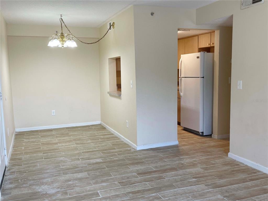 1122 South Pine Ridge Circle, Unit 1122 Sanford, FL 32773 - Photo 4 of 19 a view of a room with wooden floor and mirror