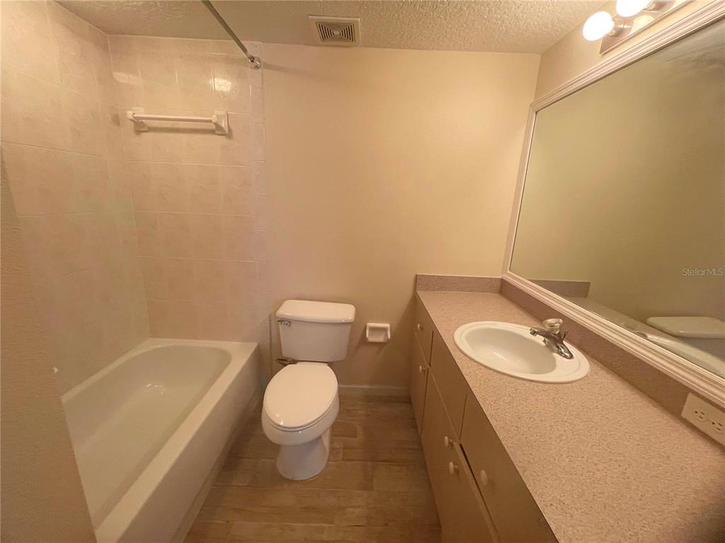 1122 South Pine Ridge Circle, Unit 1122 Sanford, FL 32773 - Photo 5 of 19 a bathroom with a sink a toilet and tub