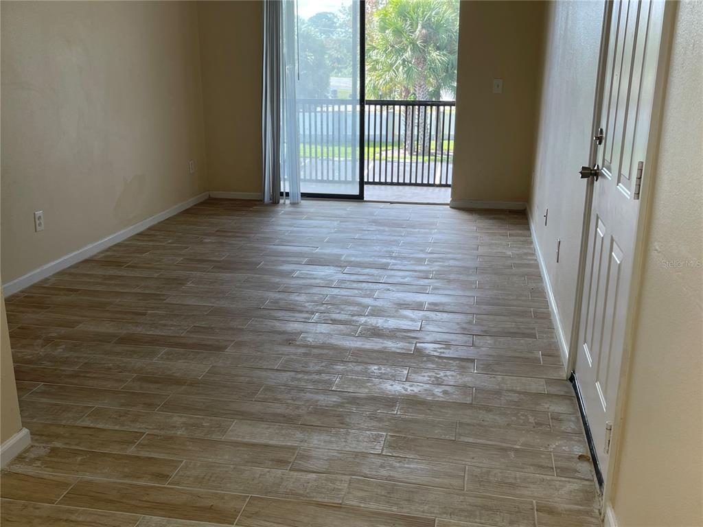 1122 South Pine Ridge Circle, Unit 1122 Sanford, FL 32773 - Photo 7 of 19 a view of a porch with wooden floor and a window