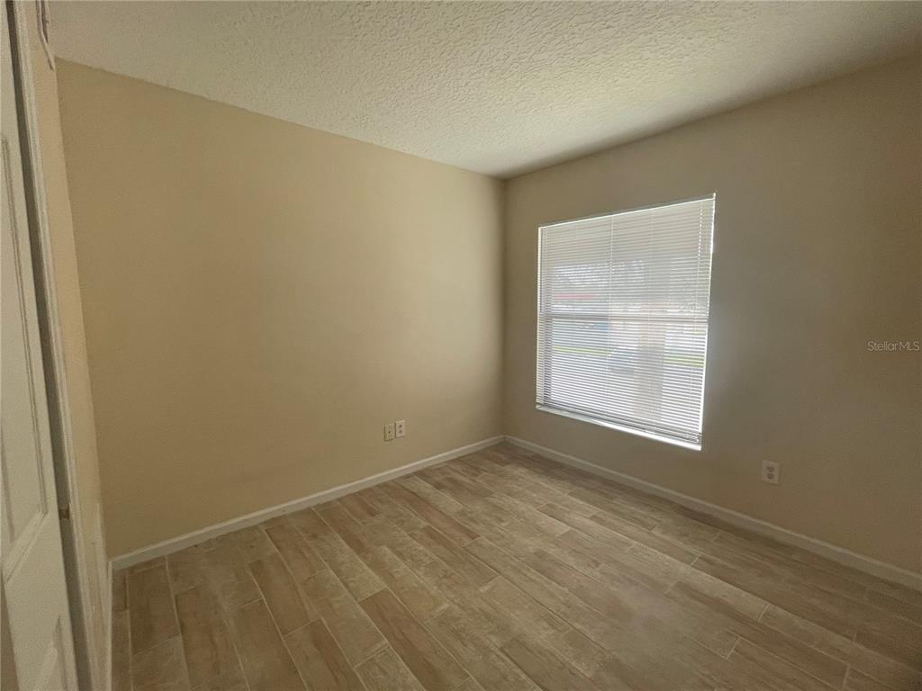 1122 South Pine Ridge Circle, Unit 1122 Sanford, FL 32773 - Photo 8 of 19 an empty room with a window
