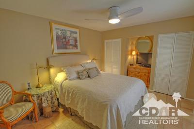 31 Medina Way Rancho Mirage, CA 92270 - Photo 18 of 25 a bedroom with a bed and wooden floor