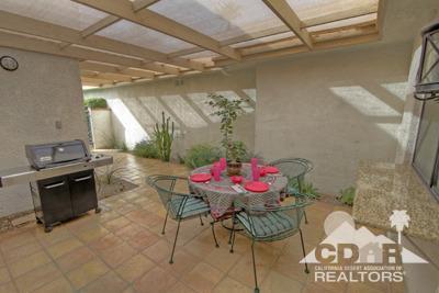 31 Medina Way Rancho Mirage, CA 92270 - Photo 19 of 25 a view of a dining room with furniture and chandelier