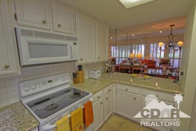 31 Medina Way Rancho Mirage, CA 92270 - Photo 9 of 25 a kitchen with a stove a sink and cabinets