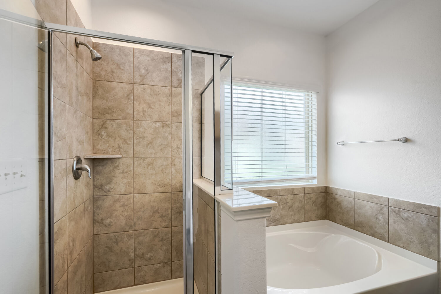2420 Ranger Pass Seguin, TX 78155 - Photo 15 of 28 Contemporary bathroom featuring a tiled shower with a glass enclosure, a built-in corner bathtub, a window with horizontal blinds, and chrome fixtures