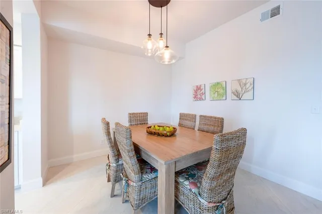 a view of a dining room with furniture and chandelier