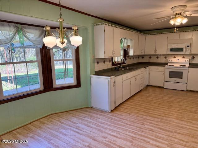 66 Quail Trail Juliette, GA 31046 - Photo 6 of 25 a kitchen with stainless steel appliances granite countertop wooden floors and white cabinets