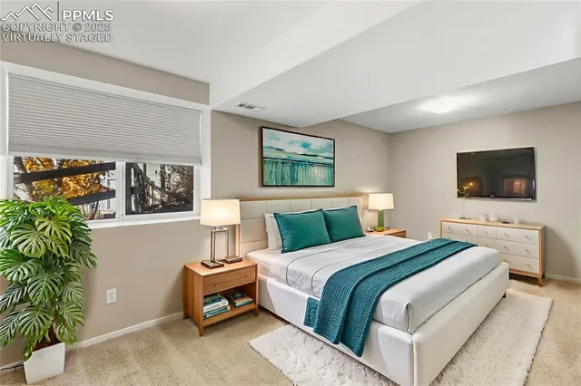 a bedroom with a bed and a flat screen tv