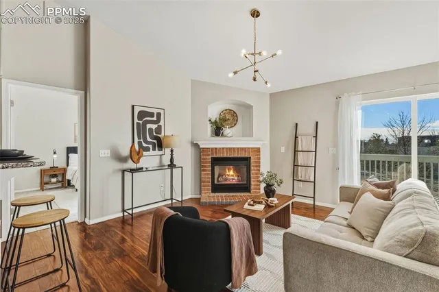 a living room with furniture two window and a fireplace