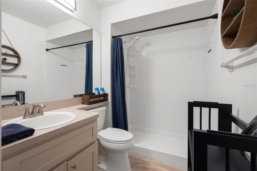 8159 Sturbridge Court, Unit 8159 Weeki Wachee, FL 34613 - Photo 15 of 27 a bathroom with a granite countertop sink toilet and shower