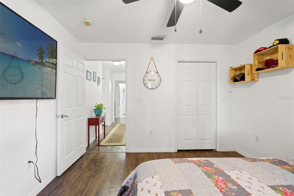 8159 Sturbridge Court, Unit 8159 Weeki Wachee, FL 34613 - Photo 16 of 27 a bedroom with a bed and wooden floor