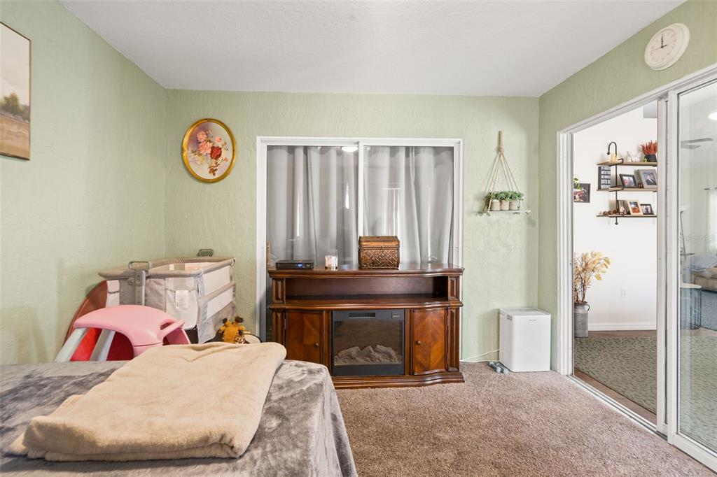 8159 Sturbridge Court, Unit 8159 Weeki Wachee, FL 34613 - Photo 18 of 27 a room with a bed and a table in it
