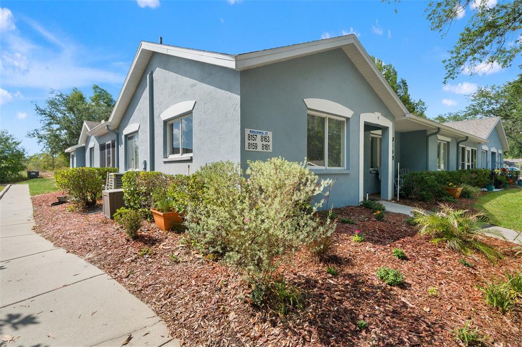 8159 Sturbridge Court, Unit 8159 Weeki Wachee, FL 34613 - Photo 19 of 27 a front view of a house with garden