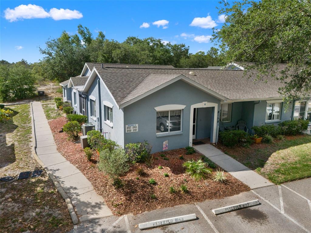 8159 Sturbridge Court, Unit 8159 Weeki Wachee, FL 34613 - Photo 20 of 27 a front view of a house with garden