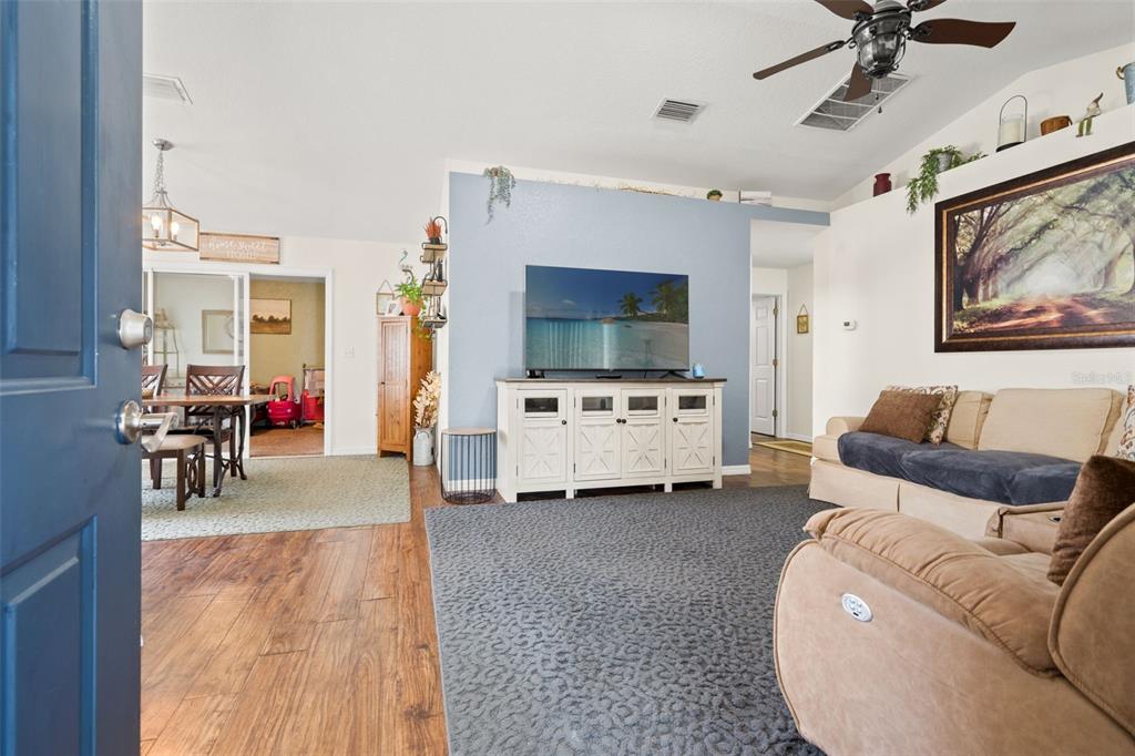 8159 Sturbridge Court, Unit 8159 Weeki Wachee, FL 34613 - Photo 2 of 27 a living room with furniture and a flat screen tv