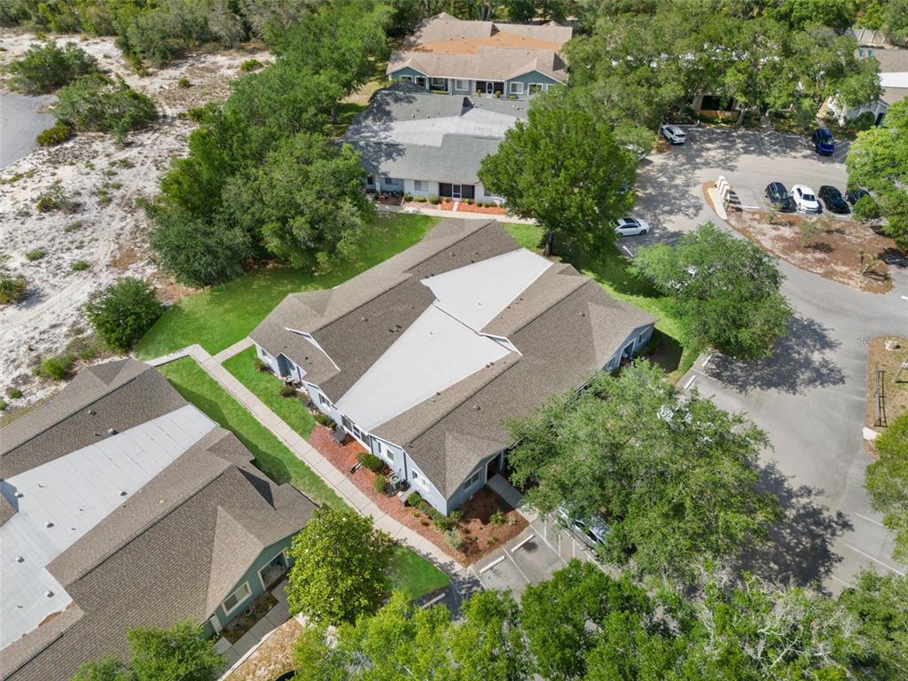 8159 Sturbridge Court, Unit 8159 Weeki Wachee, FL 34613 - Photo 22 of 27 an aerial view of a house with a yard and trees