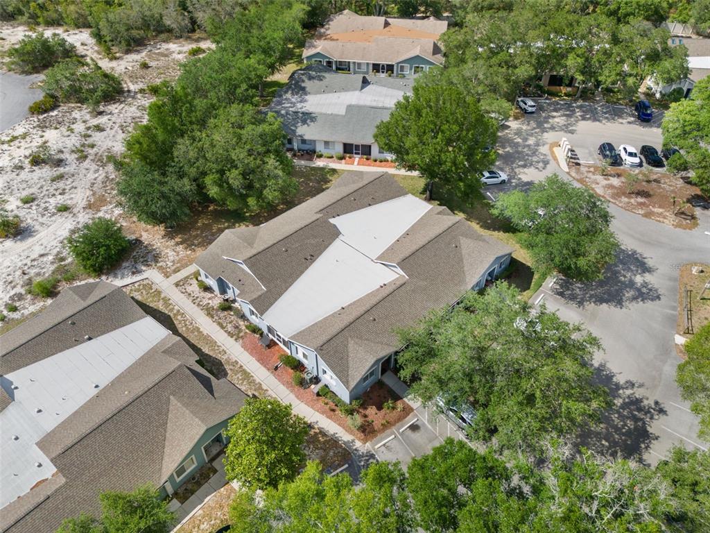 8159 Sturbridge Court, Unit 8159 Weeki Wachee, FL 34613 - Photo 24 of 27 an aerial view of a house with a yard and trees