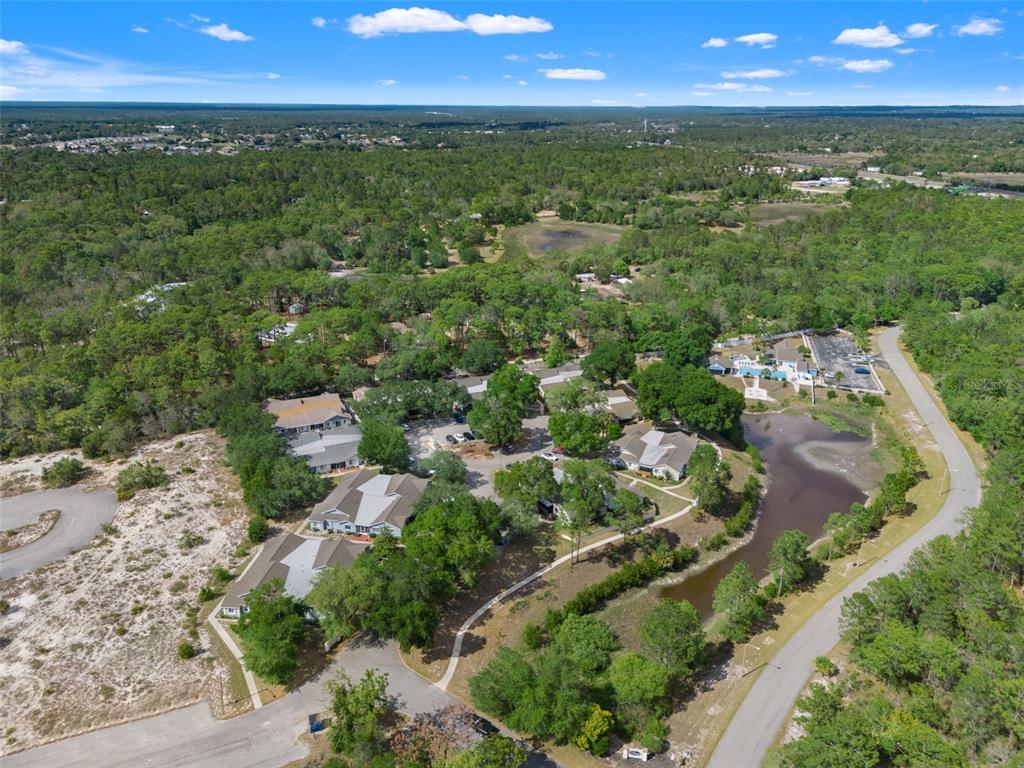 8159 Sturbridge Court, Unit 8159 Weeki Wachee, FL 34613 - Photo 25 of 27 an aerial view of residential houses with outdoor space and trees