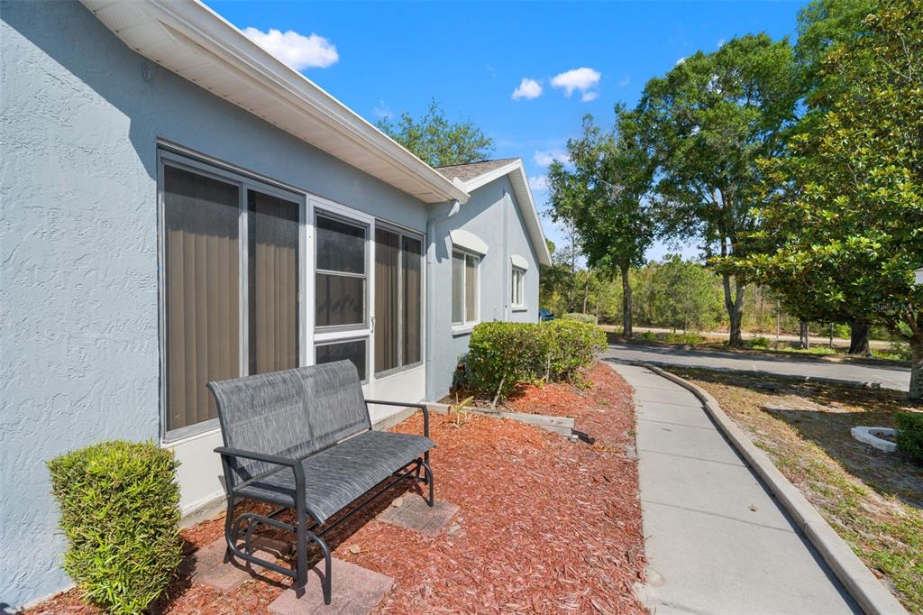8159 Sturbridge Court, Unit 8159 Weeki Wachee, FL 34613 - Photo 26 of 27 a view of a house with backyard and sitting area