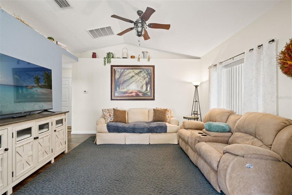 8159 Sturbridge Court, Unit 8159 Weeki Wachee, FL 34613 - Photo 3 of 27 a living room with furniture and a flat screen tv