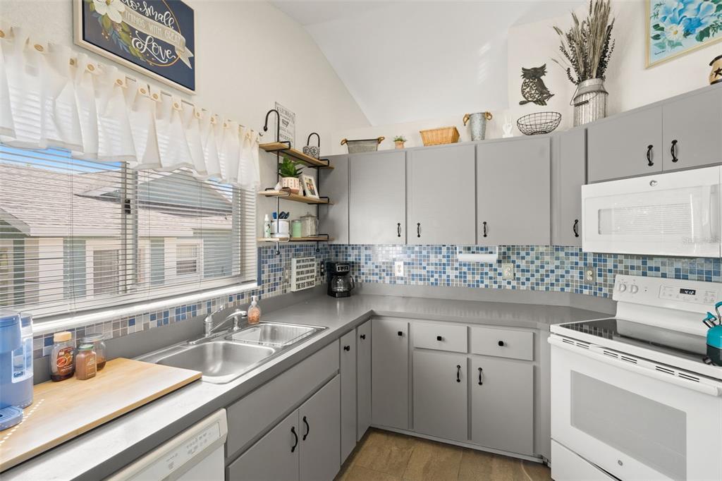 8159 Sturbridge Court, Unit 8159 Weeki Wachee, FL 34613 - Photo 6 of 27 a kitchen with cabinets and window