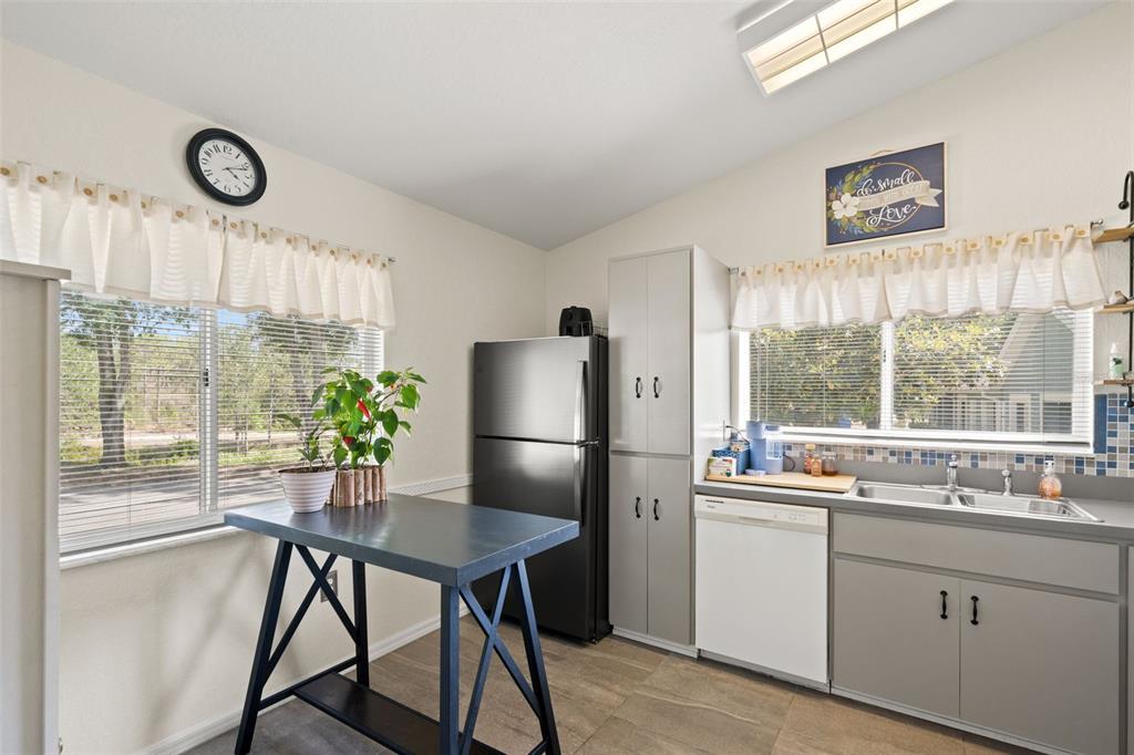 8159 Sturbridge Court, Unit 8159 Weeki Wachee, FL 34613 - Photo 8 of 27 a kitchen with a table chairs and window