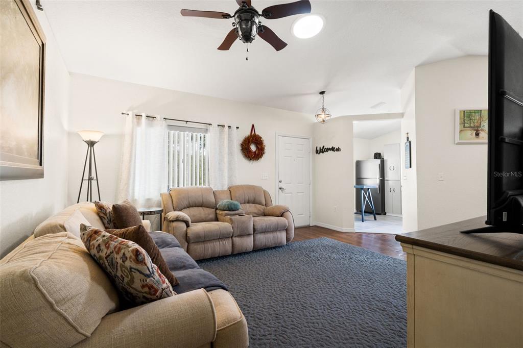 8159 Sturbridge Court, Unit 8159 Weeki Wachee, FL 34613 - Photo 9 of 27 a living room with furniture and a large window