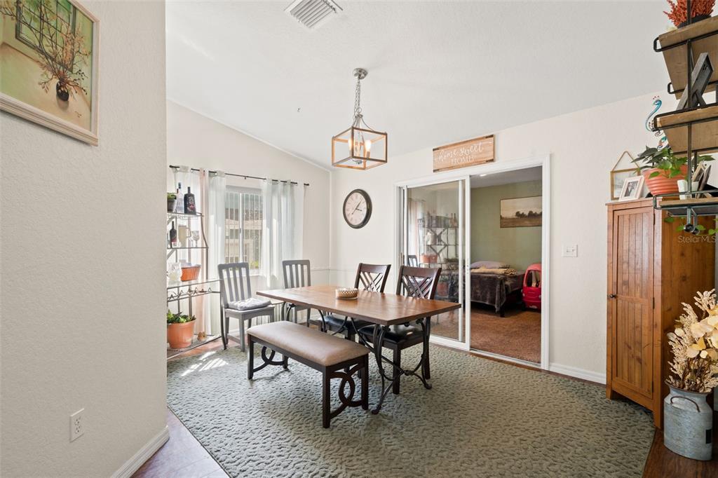 8159 Sturbridge Court, Unit 8159 Weeki Wachee, FL 34613 - Photo 10 of 27 a view of a dining room with furniture