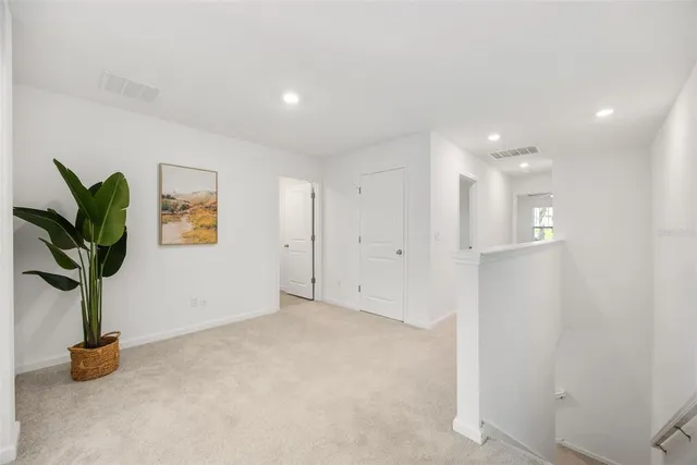 an empty room with a window and a ceiling fan