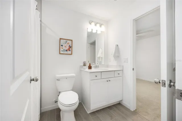 a bathroom with a toilet sink a mirror and shower