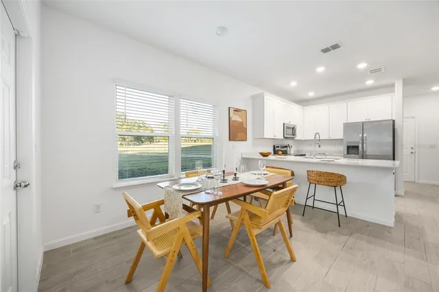 a kitchen with a table and chairs in it