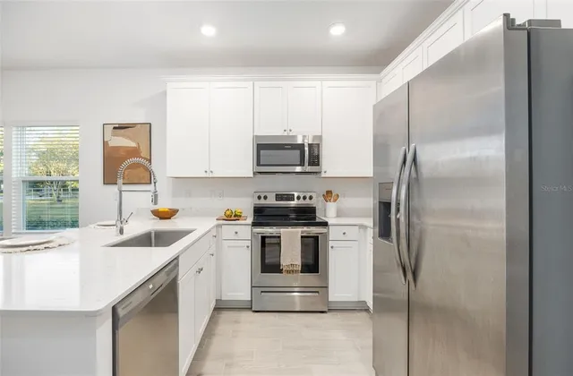 a kitchen that has a refrigerator and a sink