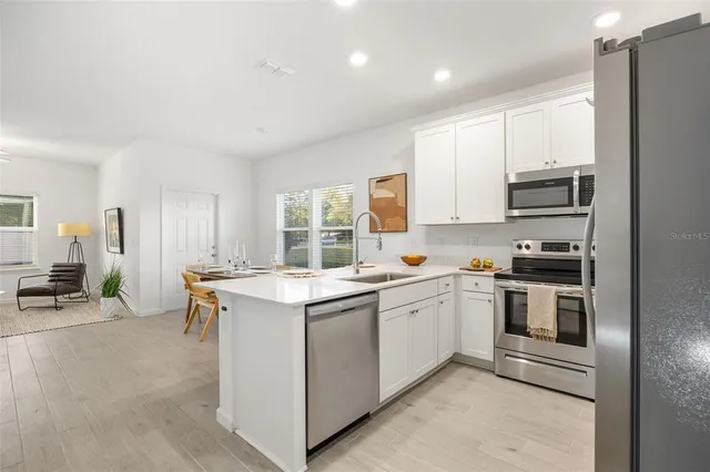 a kitchen with a sink stove and cabinets
