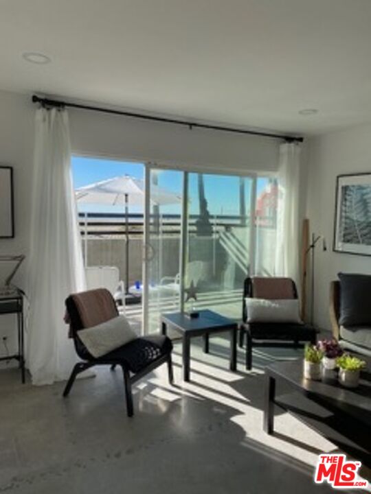 2609 Ocean Front Walk Venice, CA 90291 - Photo 15 of 17 a living room with furniture and a flat screen tv