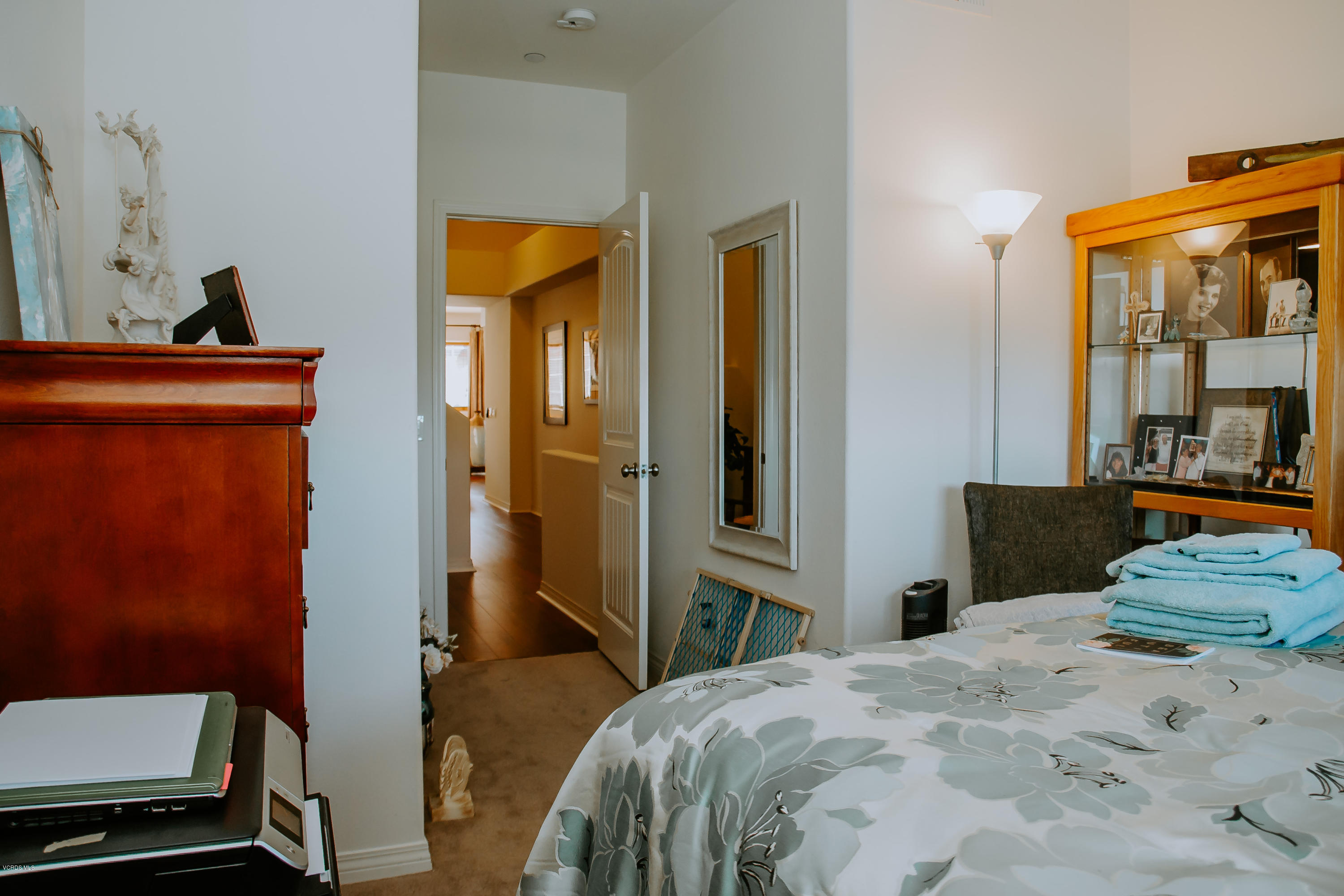 3012 Moonlight Park Avenue Oxnard, CA 93036 - Photo 13 of 59 a bedroom with a bed and wooden floor