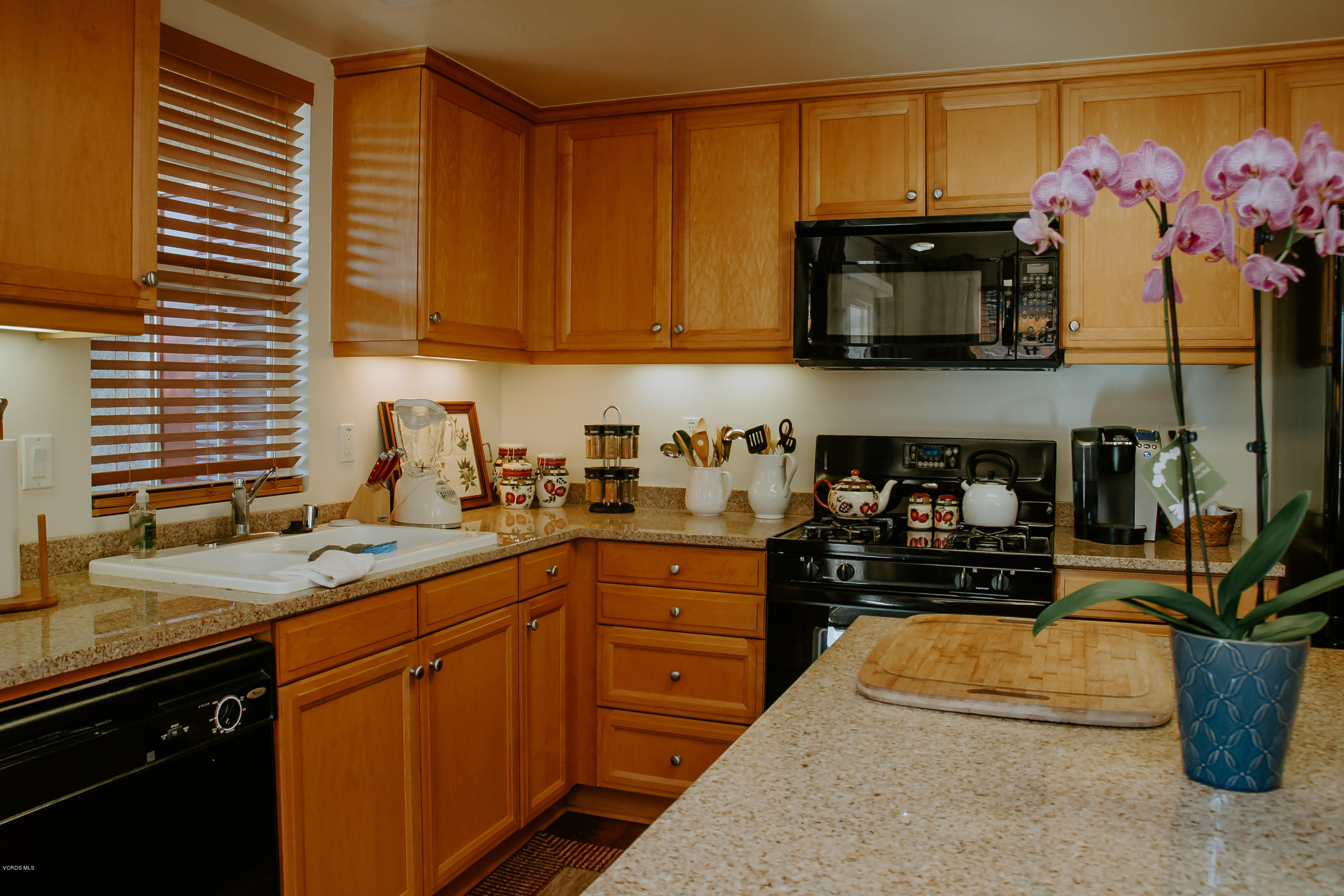 3012 Moonlight Park Avenue Oxnard, CA 93036 - Photo 21 of 59 a kitchen with stainless steel appliances granite countertop a sink stove and microwave