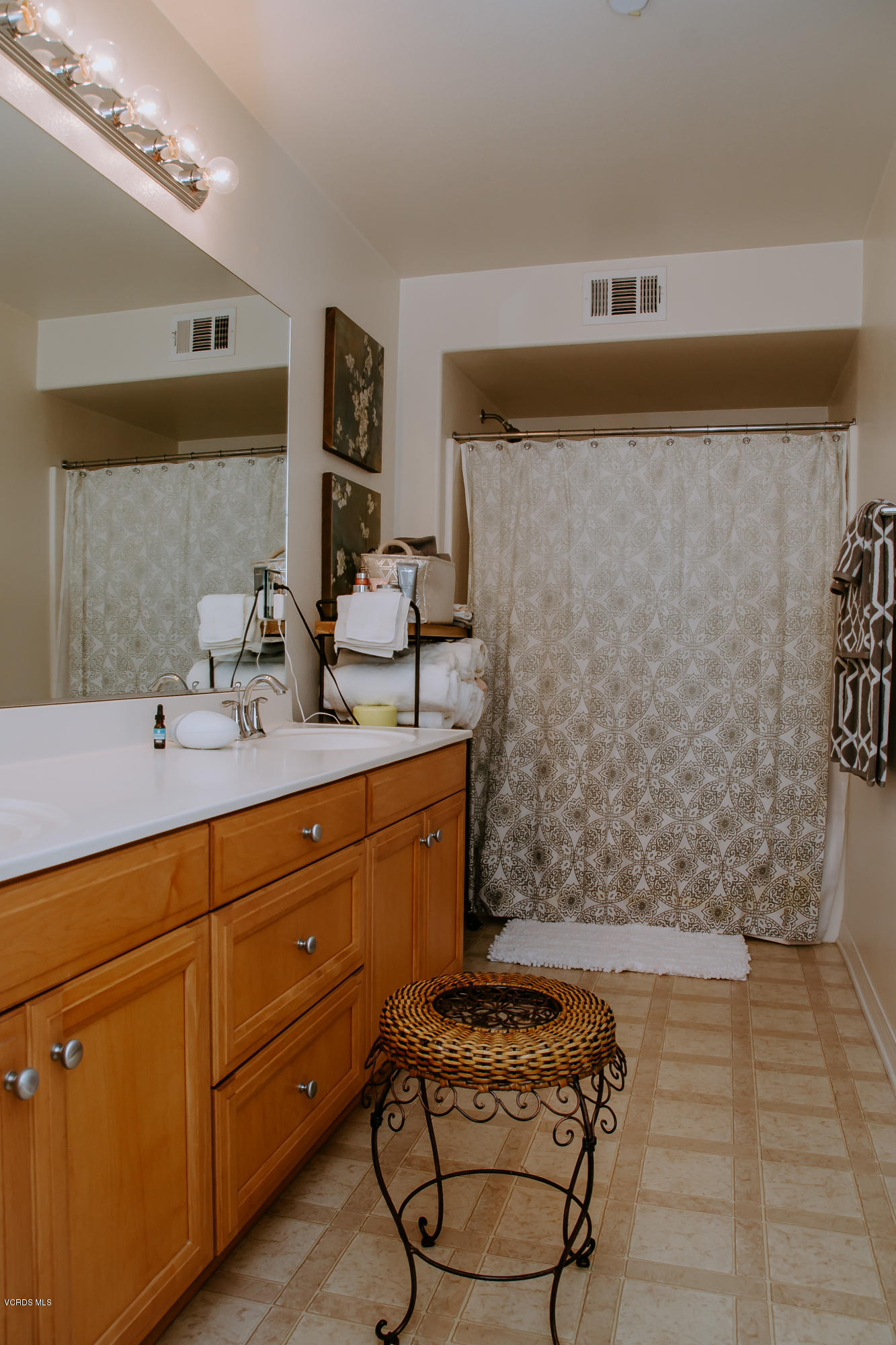 3012 Moonlight Park Avenue Oxnard, CA 93036 - Photo 41 of 59 a bathroom with a sink a mirror and shower