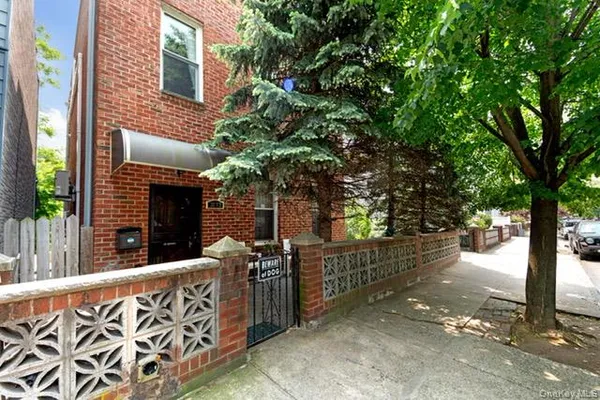 a view of a wooden house with a large tree