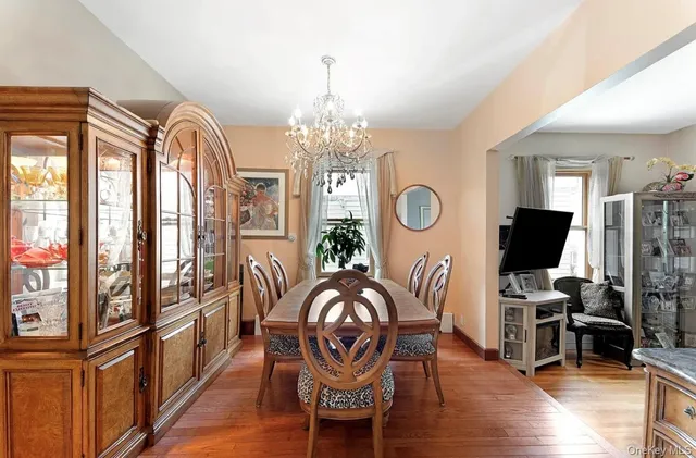 a view of a livingroom with furniture window wooden floor and chandelier