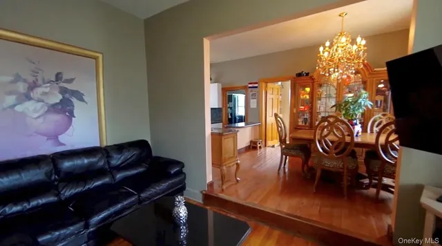 a view of a dining room with furniture and chandelier