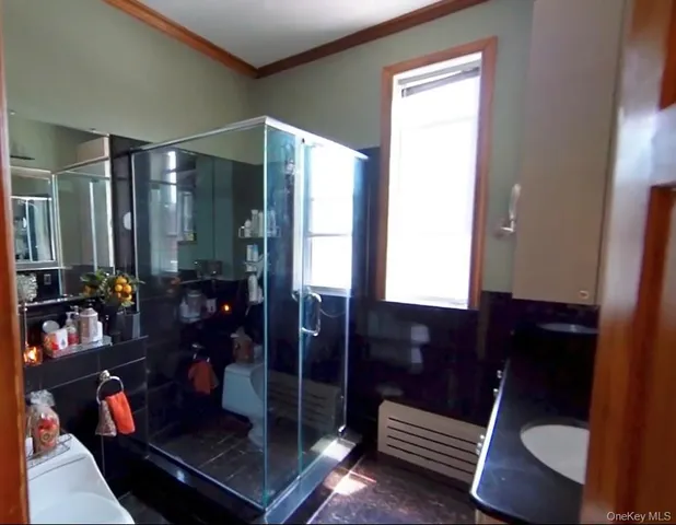a bathroom with a glass shower door