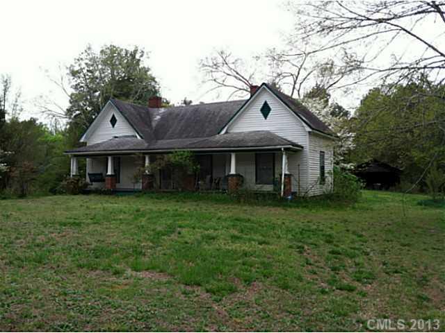 5750 Tuckaseegee Road Kannapolis, NC 28081 - Photo 1 of 3 a front view of a house with a garden and trees