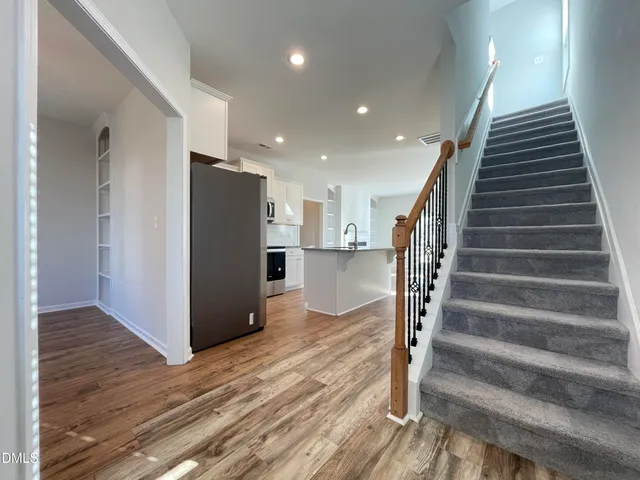 a view of entryway with wooden floor and stairs