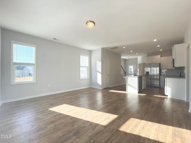 a view of a kitchen with a sink and a large window