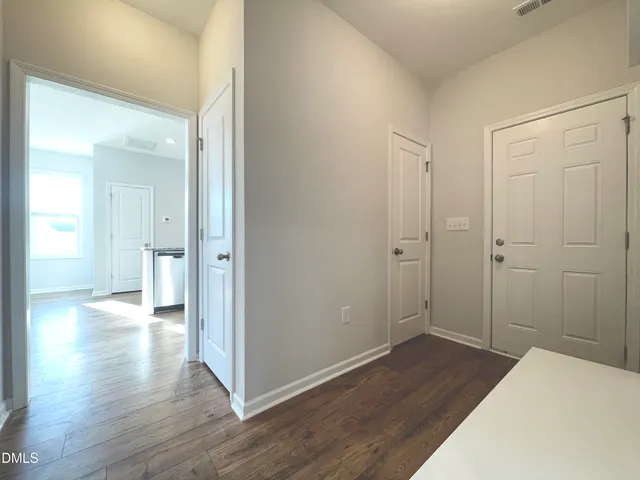 a view of a room with wooden floor
