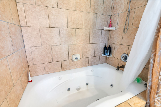 1727 South Sandhill Road Orem, UT 84058 - Photo 13 of 27 Tiled shower and tub surround featuring a built-in jetted tub